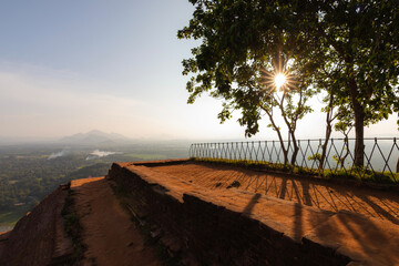 Scenic view looking over vast tropical landscape from Sigiriya Rock in Sri Lanka. Ancient rock fortress rising above jungle plains and villages, representing history, nature, and iconic travel.