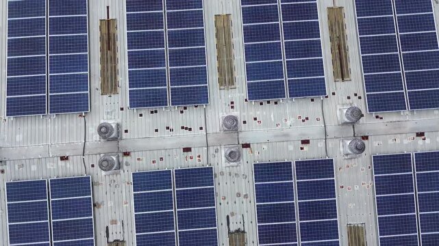 Drone Rotating Around Center Above Solar Panel Rooftop Creating Symmetrical Geometric Pattern