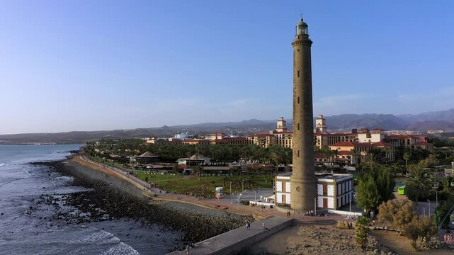 Lighthouse of Maspalomas at Gran Canaria Island known as Faro de Maspalomas at sunset. Seascape with lighthouse and Maspalomas beach. Gran Canaria, Canary Islands, Spain