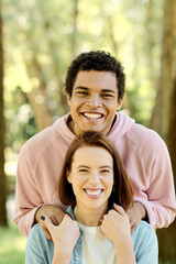 Fototapeta premium Couple enjoys a joyful moment in a sunny park, celebrating love and connection