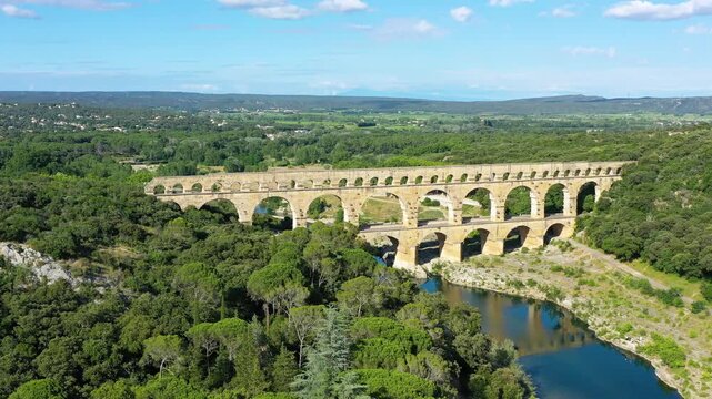 Exploring the majestic Pont du Gard aqueduct in France, discover the stunning architecture of the ancient Pont du Gard aqueduct in southern France. River Gard, Languedoc-Roussillon, France.