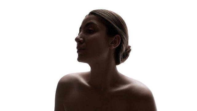 Artistic low light portrait of woman with dramatic silhouette. Concept of emotional depth, inner strength, visual contrast, and contemporary conceptual photography.