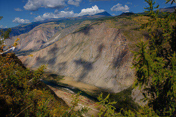 Scenic mountain landscape with river valley and majestic clouds