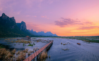 Panorama landscape Sunset view of wooden bridge in lotus lake at khao sam roi yot national park,...