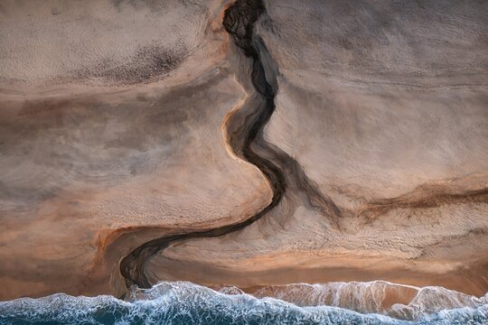 Meandering stream meets ocean shore
