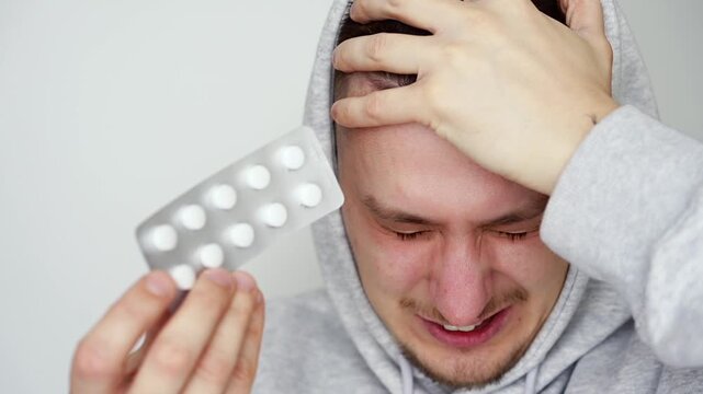 A man holds migraine tablets.
Headache and cold treatment