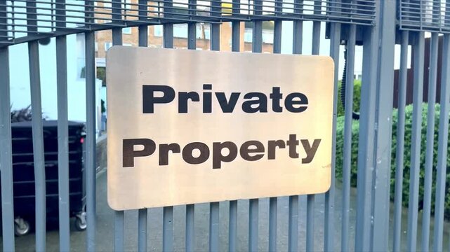 private property shiny metal sign attatched to residency metal gates
