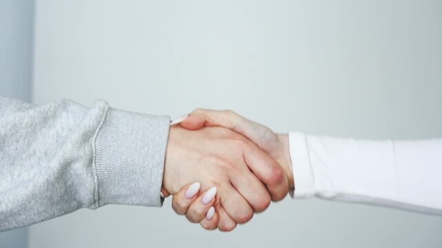A gesture of greeting two people.
greeting when meeting and shaking hands with loved ones.