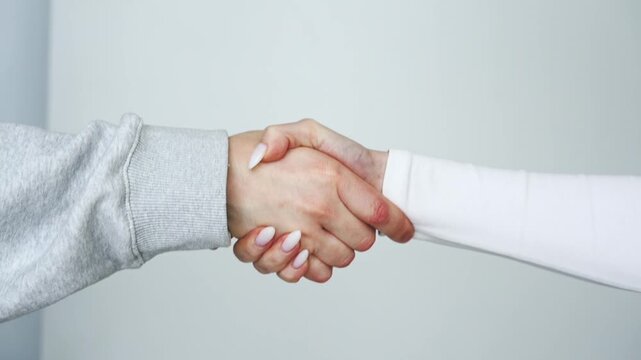 A greeting gesture with hands.
A man and a woman greet each other and shake hands.
Touching hands