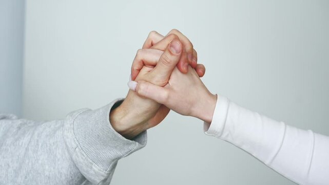A close-up of two hands touching.
A man's and a woman's hand touching each other against a white background.
A gesture of friendship and support.
Help in a difficult situation.
Friendly hand gestures