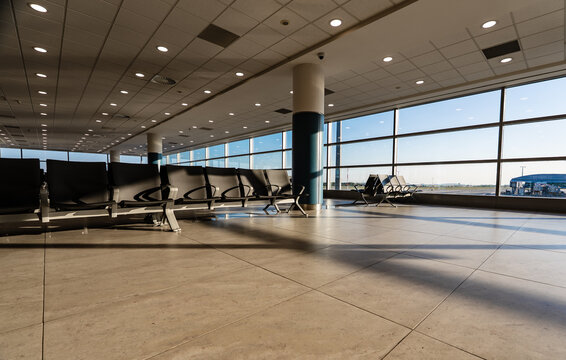 Empty waiting area with seats in a modern international airport terminal.