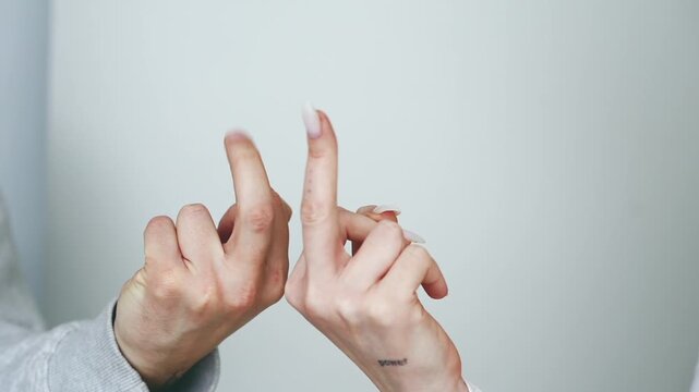 A man and a chewing gum are making a "FUCK YOU" gesture with their fingers.
Obscene hand gestures.
Angry and aggressive gestures.