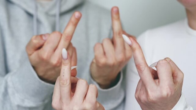 Human conflict.
Negative and provocative hand gestures.
Close-up of the "Fuck" gesture.