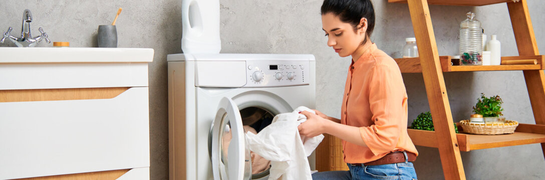 Young woman tidying her modern apartment with a focus on laundry tasks