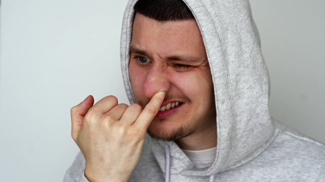 The disgusting and vile habit of picking one's nose.
A man fell asleep with his finger in his nose.
Close-up of a man's finger in his nose.