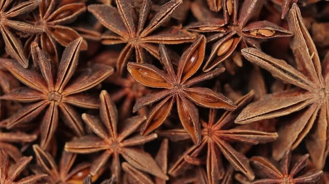 Pile of star anise rotating slowly for a background. Top view shot
