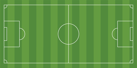Top-down aerial view of a green soccer field with white markings, including the center circle, penalty areas, and goals. © achmad