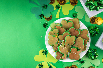 Shamrock shaped green tasty sweet pancakes for St Patricks day breakfast. Creative homemade tasty fried pan cakes with sugar sprinkles and Saint Patrick holiday decor