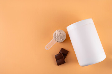 Chocolate collagen powder and drink on beige background, Plastic jar mock-up with chocolate collagen powder, portion scoop and glass with cocoa collagen drink with pieces of chocolate