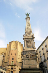 View of the Obelisk of the Immaculate Conception, a historic monument located in Naples, Campania, Italy.