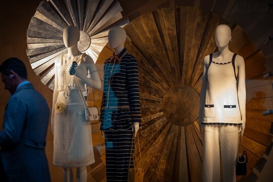 Milan, Italy - 2026, 13 Jan: Elegant Chanel FW25 window display with chic mannequins, metallic gold accents, and sophisticated fashion in a luxury boutique setting