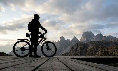 Mountain Biker Silhouette at Sunset on Scenic Alpine Trail ai generated