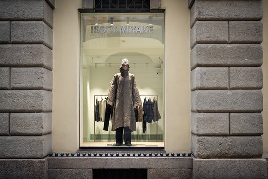 Milan, Italy - 2026, 13 Jan: Striking Issey Miyake FW25 window display features avant-garde outerwear, modern textures, and urban luxury in a premium boutique setting