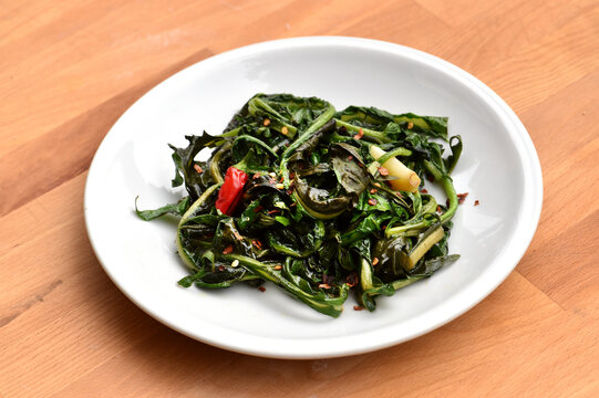 Cicoria ripassata con aglio e peperoncino or cicoria with garlic and chili is a typical food of Rome area in Italy