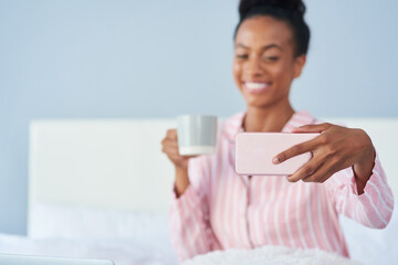 Black woman, selfie smile and relax in bed for social media update, coffee and morning in home....