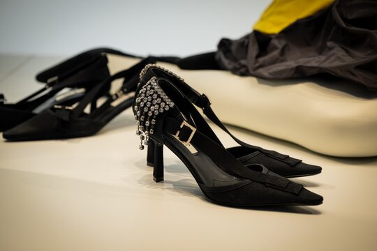 Milan, Italy - 2026, 13 Jan: Prada FW25 black heels with crystal details, showcasing luxury craftsmanship and modern elegance in a chic boutique setting