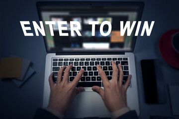 Business hands typing on a laptop with the words "Enter to Win". Concept of online contest, giveaway, raffle, or lottery