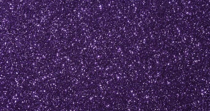 Macro close-up of glitter surface with shimmering sparkles and bokeh highlights. Abstract festive texture in multiple colors