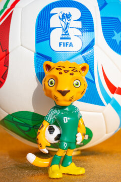 ZHONGSHAN China-November 17 2025: mascot Zayu and the soccer for the 2026 FIFA World Cup on a golden background at vertical composition.