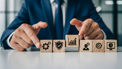 Businessman Arranging Wooden Blocks with Business Icons