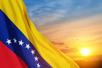 Fototapeta premium Venezuela flag on background of sunset sky. Patriotic concept. Banner with place for text.