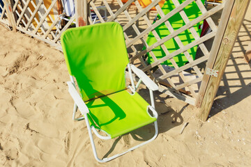 Closeup of green chair in the beach