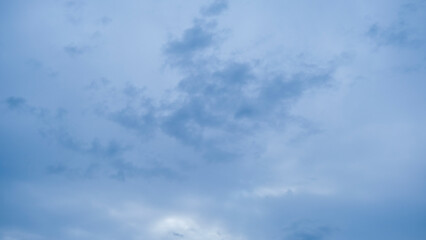 Fototapeta premium Panoramic view of white fluffy clouds drifting across a bright blue sky on a clear day