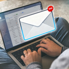 Remote Worker Receiving a High Volume of Unread Emails, Notified by a 999+ Badge on a Digital...