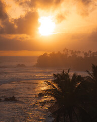 Golden Sunset Over Tropical Beach With Silhouetted Palm Trees