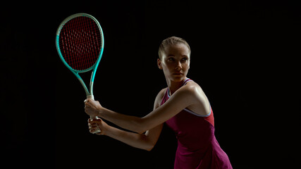 Female tennis athlete preparing for return shot on black background. Concept of concentration, pre-match focus, professional sport training and mental readiness.