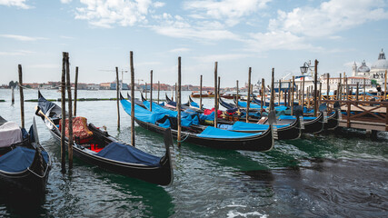 Fototapeta premium Gondolas Moored Along Venetian Waterfront