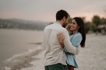 Romantic couple embracing on the beach at sunset