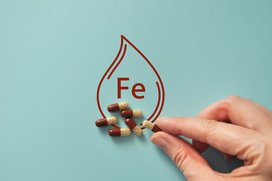 Iron Supplement Concept with Pills and Drop Icon