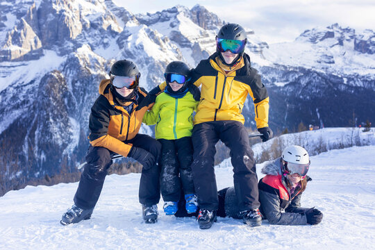Happy family in winter clothing at the ski resort, winter time