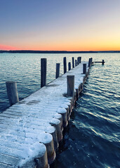 frozen wooden pier on the beach in winter season