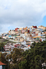 Fototapeta premium Dense colorful hillside cityscape with traditional houses in Gran Canaria, Canary Islands, Spain
