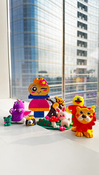 Playful Clay Art Creations Brightens Windowsill Against Modern Cityscape