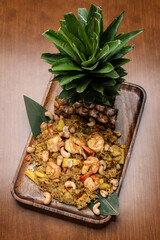Thai chicken fried rice with pineapple and cashew on modrn bangkok restaurant table in thailand
