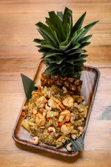 Thai chicken fried rice with pineapple and cashew on modrn bangkok restaurant table in thailand