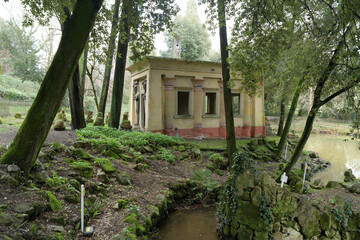 Egyptian-style temple by a pond in Stibbert Park, romantic English garden created by Frederick Stibbert in Florence, Italy.